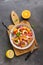 Ceviche with shrimps and orange in a plate on a cutting board. Flat lay, overhead view