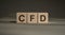 CFD - acronym from wooden blocks with letters, Contract For Difference CFD investment concept