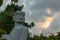 Chac Mool statue closeup detail on face against cloudy sky