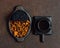 Chaga mushroom and chaga tea in a wooden tray on a dark brown background. Top view, flat lay