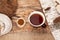 Chaga tea in a cup on a wooden table in a rustic style. Nearby are natural Chaga birch mushrooms. Top view