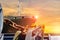 Chain anchor on front of deck ship with sunset.