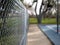 Chain link fence around basketball courts in park