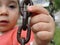 Chain links on swing in hands of small child