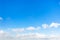 Chain of little cumuli clouds in blue sky