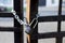 Chain and lock on the iron fence. Closeup view. Sharp lock. Blur