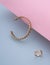 Chain shape design bracelet and ring set on pastel colors blue and pink background