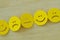 Chain of yellow smiley faces with positive, neutral and negative expression