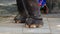 Chained elephant legs close up, human legs in the background. concept of one enjoying freedom while some cannot