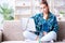 The chained female student with laptop sitting on the sofa