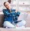 Chained female student with laptop sitting on the sofa