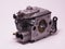 Chainsaw carburetor on a white background.