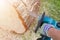 Chainsaw. Chainsaw in move cutting wood. Man cutting wood with saw. Dust and movements. Close-up of woodcutter sawing chain saw.