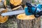 Chainsaw. Close-up of woodcutter sawing chain saw. Close up professional chainsaw blade cutting log of wood. Chainsaw bar