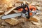 Chainsaw for a tree. Sawing firewood outdoors