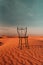 Chair in desert: An intriguing sight, a lone chair stands amidst the barren expanse, a silent enigma that sparks curiosity and