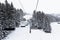 Chair lift in ski center les arcs, paradiski on the french alps on a winter snowy day