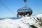 The chair lift with skiers and snowborder