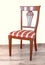 The chair is made in classical style from red wood and upholstery from a tapestry.