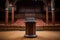 A chair with a microphone in a large concert hall. Speaker's rostrum in a huge hall, spotlight illumination