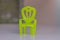Chair plastic made, painted in green on white background