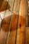 Chair shadow on rough wooden floorboards