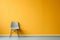 a chair sits in front of an orange wall