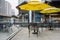 Chair and tables under sunshades on fenced terrace at Taikooli