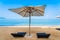 Chair umbrella and lounge on the beautiful beach sea ocean on sky