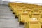 A chair for watching sports on the amphitheater. Chairs lined up in the stands.