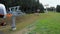 Chairlift bottom station of grassy slope and hikers. Summer in ski region Ore mountains