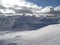 Chairlift in front of snow covered mountain peaks in the alps