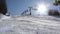 Chairlift lifts skiers up the mountain above an empty ski slope