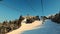 chairlift in ski resort in beautiful sunny winter season in mountains POV view footage