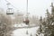 Chairlift in snowfall at alpine ski resort