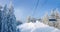 Chairlift in a spruce forest in ski resort in Carpathians