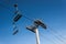 Chairlifts on a blue clear ski during on a bright day