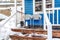 Chairs against blue wall of home with wet and snowy porch and stairs in winter