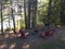 Chairs around a metal fire pit during summer.