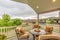 Chairs around table with fire pit at a residential balcony framed with railings