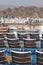 Chairs on blue ship deck in port near mountains