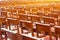 Chairs in the church in the prayer hall, wooden brown armchairs in rows behind