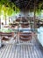 Chairs and dining glass tables on wooden floor, restaurant interior