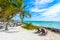 Chairs and Hammock under the palm trees on paradise beach at tropical Resort. Riviera Maya - Caribbean coast at Tulum in Quintana