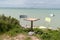 chairs and metal table on seacoast summer in coffee restaurant empty with sea beach background