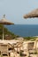 Chairs and parasols for guests of the old defence tower of Punta de N`Amer