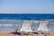 Chairs on the sandy beach near the sea