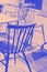 Chairs in a street cafe. Details, fragment, purple and beige toned