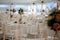 Chairs and table decorated with flowers, served with cutlery and crockery and covered with a tablecloth