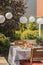 chairs at table with fruits in the garden with plants and white lanterns during party. Real photo